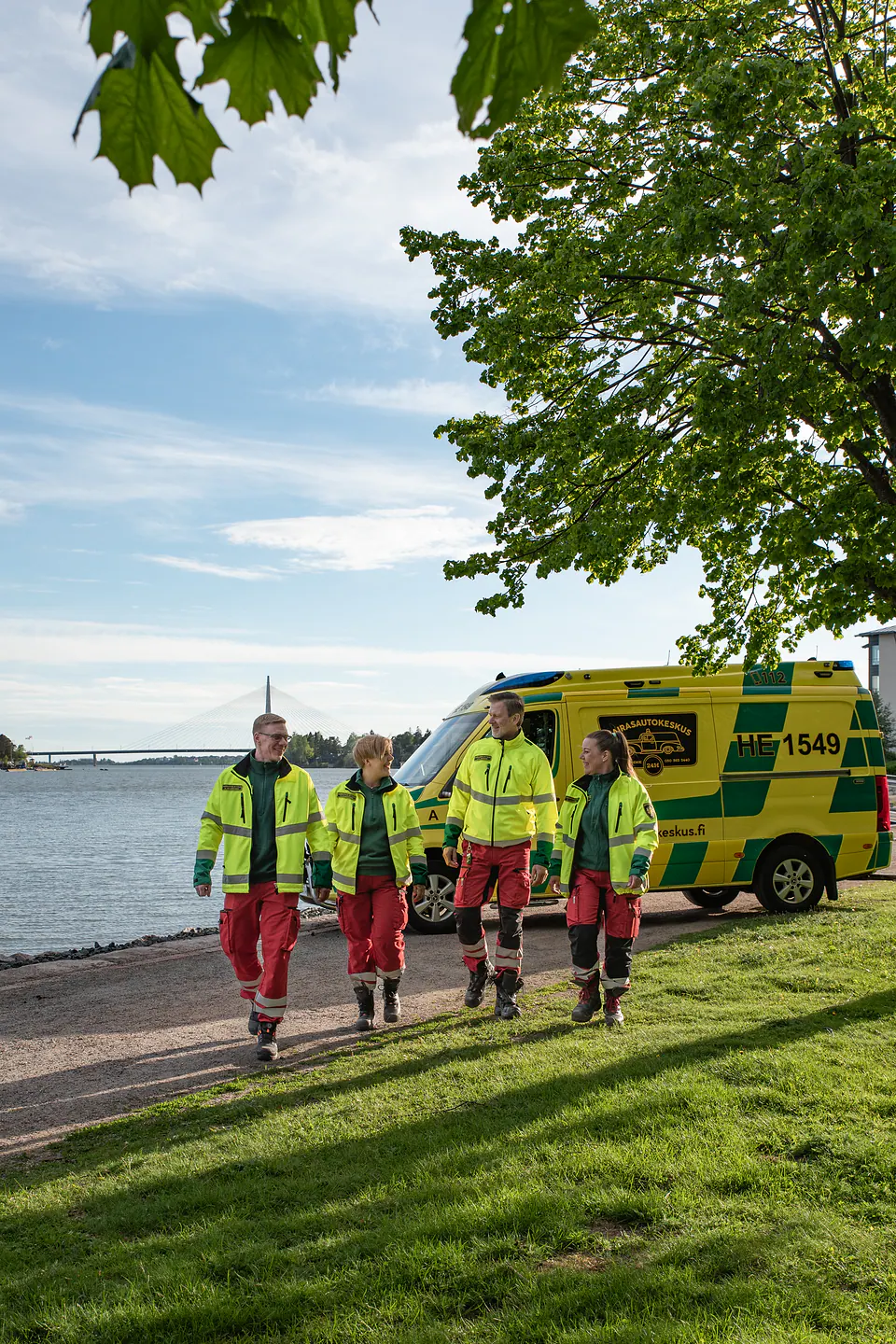 Sairasautokeskus team beside an ambulance